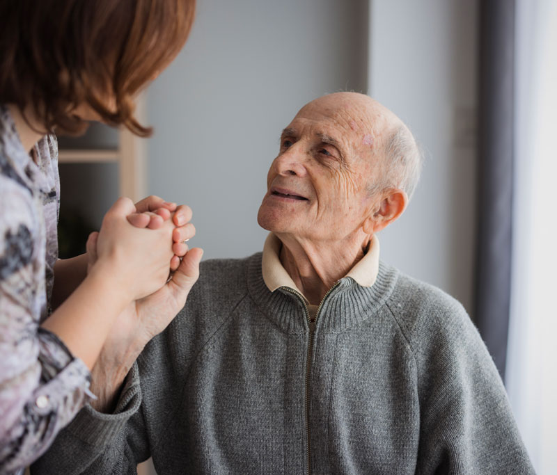 Elderly man looking at his daughter with love