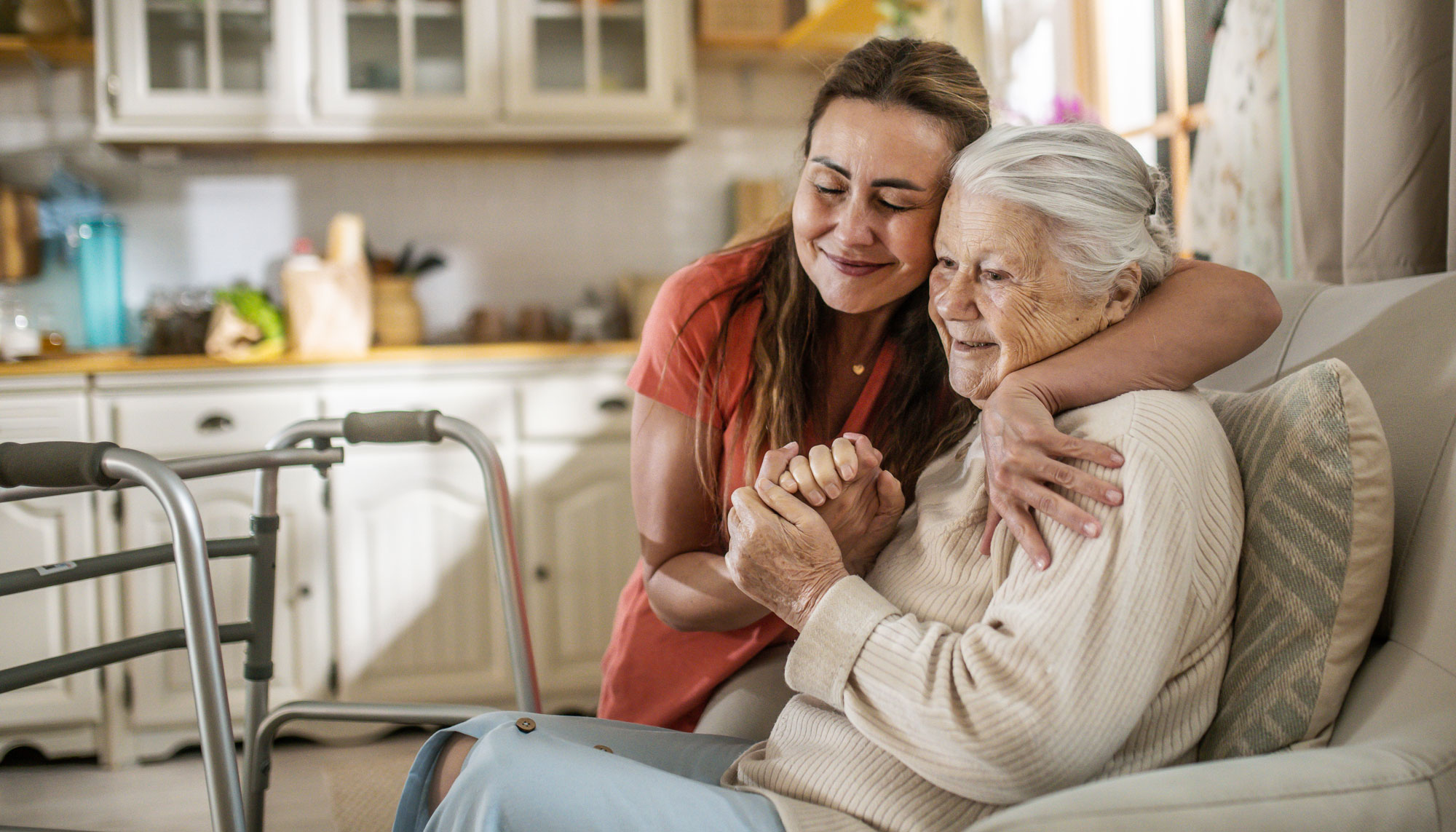 Daughter Assisting Senior Woman with Walker at home